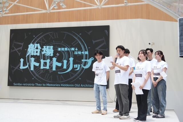経済学部総合経済政策学科教授 片岡博美ゼミの学生が、大阪ヘルスケアパビリオン リボーンステージで、謎解きゲームのプレゼンを実施